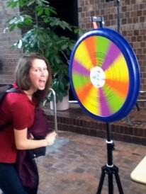 Student spinning the trivia wheel at the Green Energy Fair