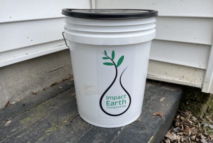 White bucket with Impact Earth logo