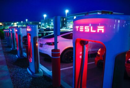 Tesla charging docks lit up at night