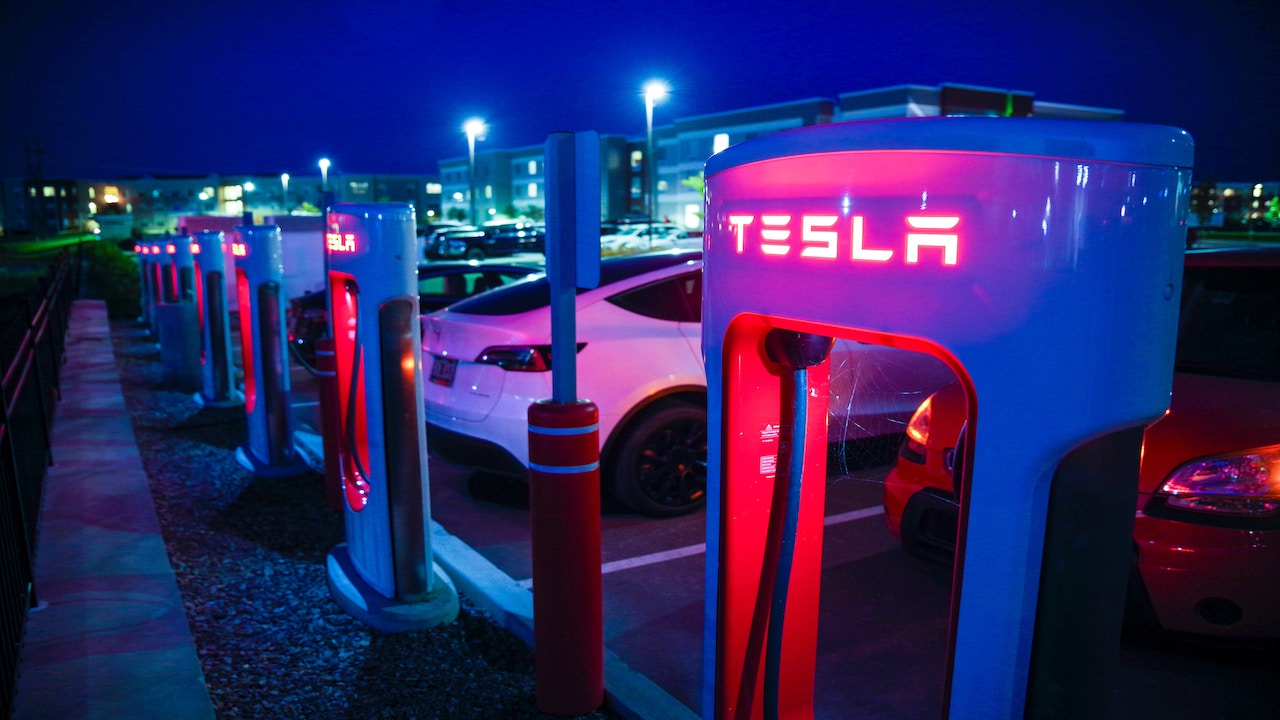 Tesla charging docks lit up at night