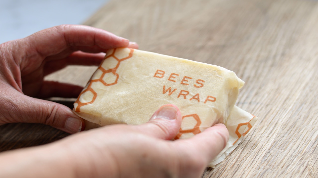 image of a person's hands holding an item wrapped in a beeswax wrap.