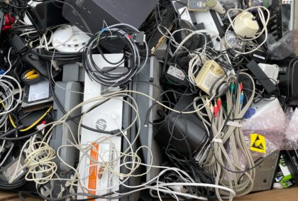 picture of old electronic chords, computer parts, and wires for recycling