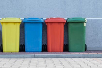image of four recycling totes in yellow, blue, red, and green