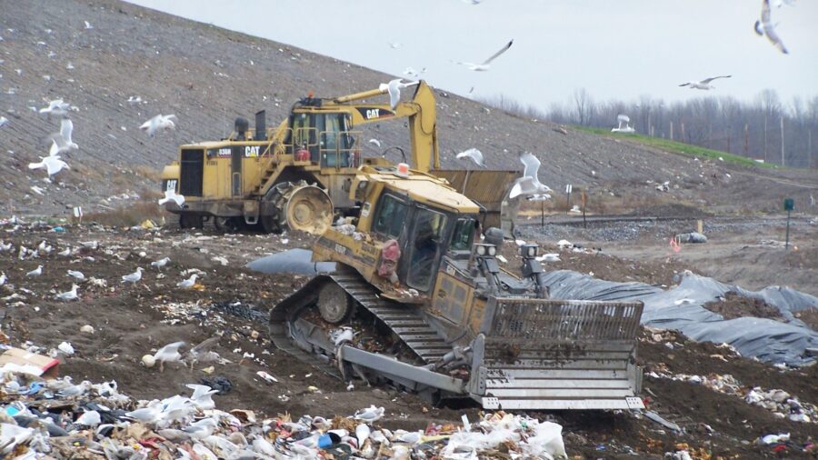 image of trucks at the landfill with sea gulls flying