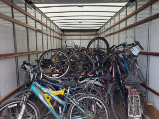 image of donated bikes in large moving trucks
