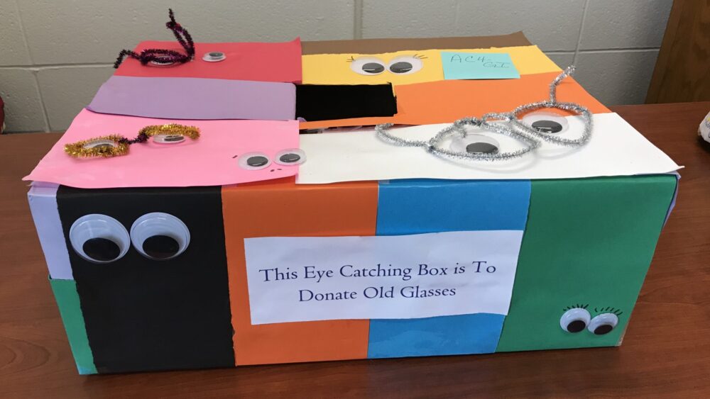 image of a box for eyeglass collection. The box is covered in colorful construction paper and googley eyes.